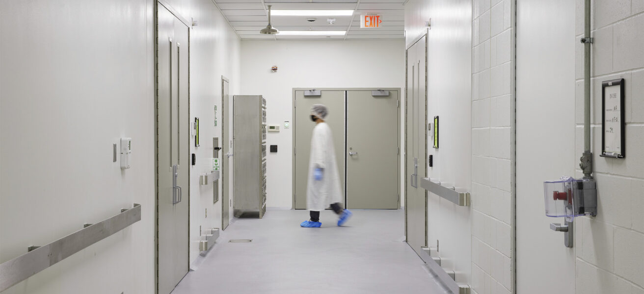A fully gowned person walks through a Tapemark clean corridor.