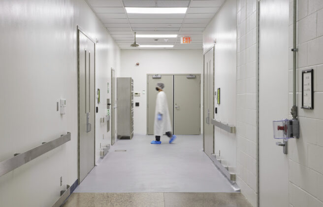 A fully gowned person walks through a Tapemark clean corridor.