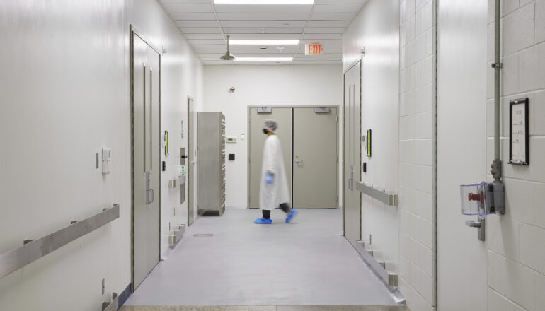 A fully gowned person walks through a Tapemark clean corridor.