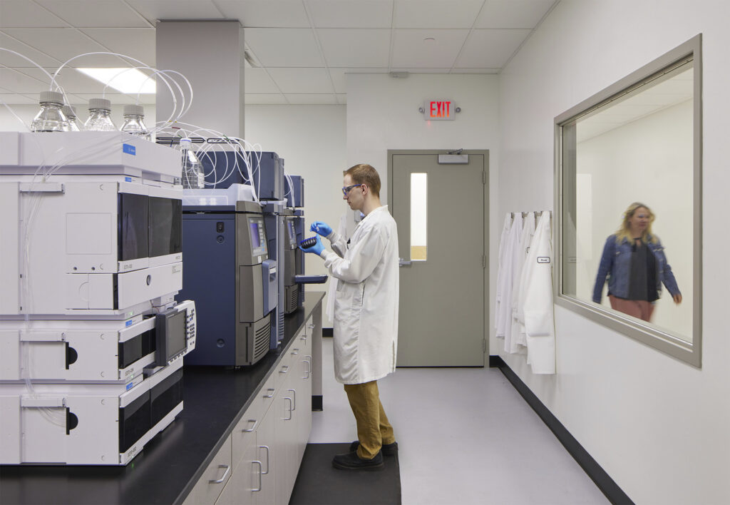 A person performs tests in a Tapemark cleanroom.