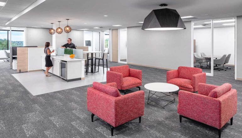 Coffee station with bright red furniture for impromptu meetings.