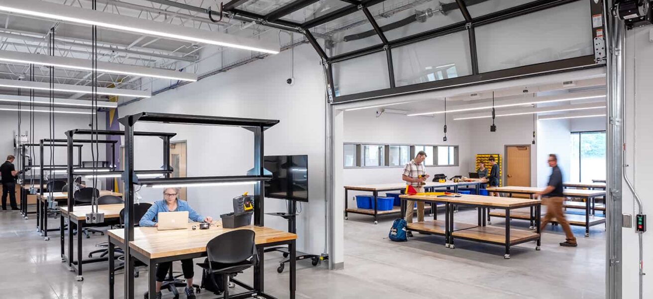 Rolling overhead garage doors create temporary separation between labs and workshops.