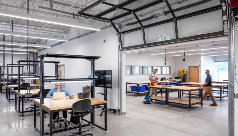 Rolling overhead garage doors create temporary separation between labs and workshops.