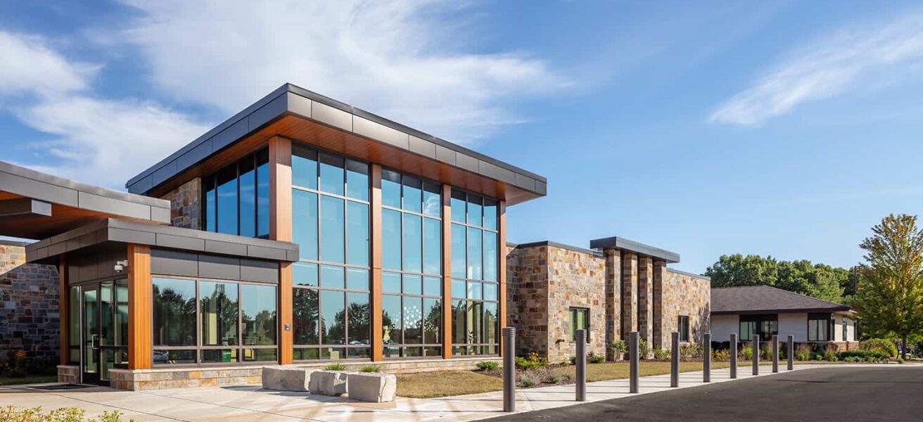 Exterior entry with double-height glass lobby.