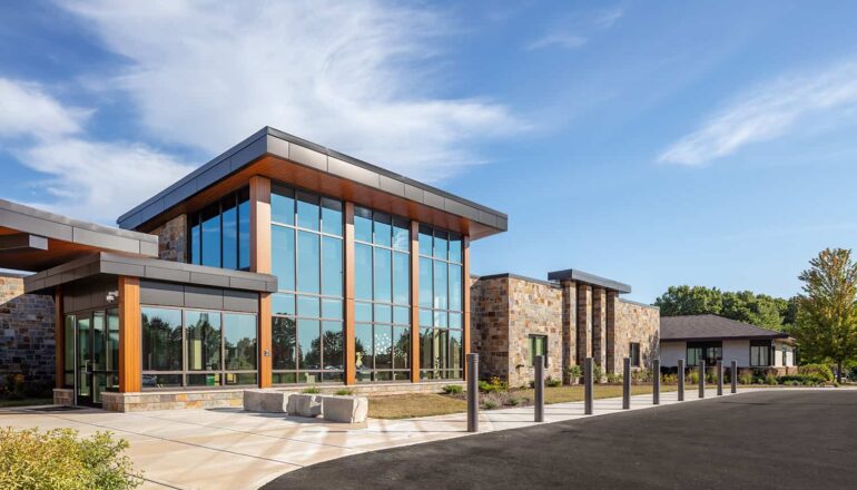 Exterior entry with double-height glass lobby.