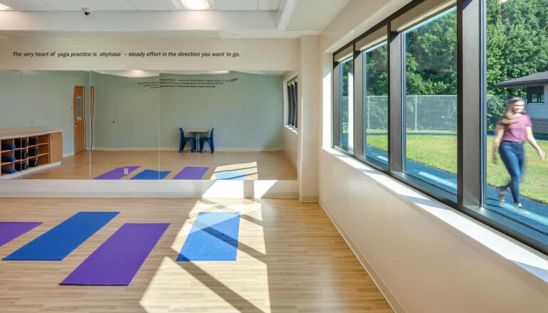 Meditation studio with expansive windows and view to a small walking track.