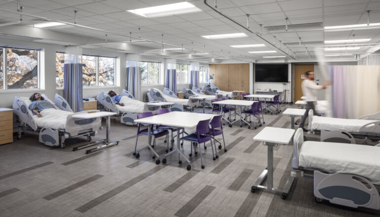 A view of a nursing simulation lab with numerous patient mannequins.