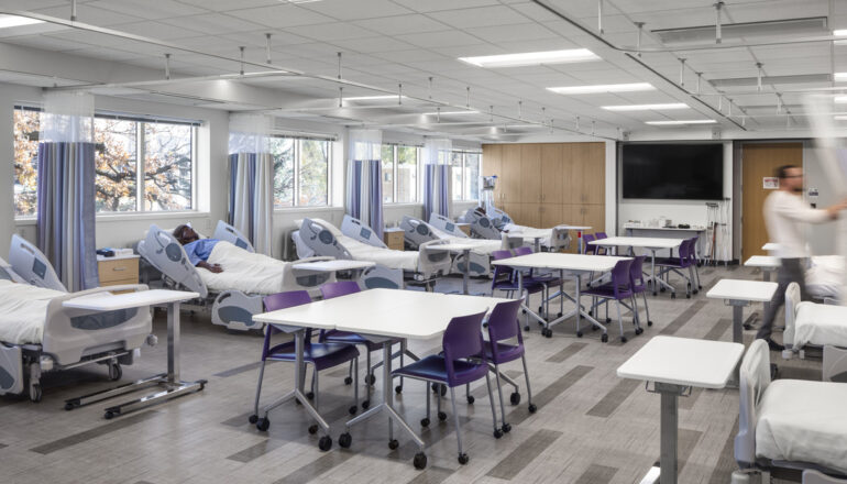 A view of a nursing simulation lab with numerous patient mannequins.