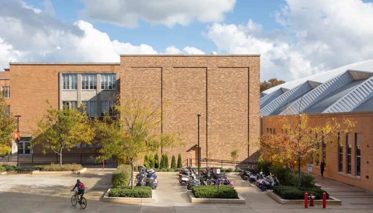 Overall exterior view of the high-bay materials lab and student moped parking area.