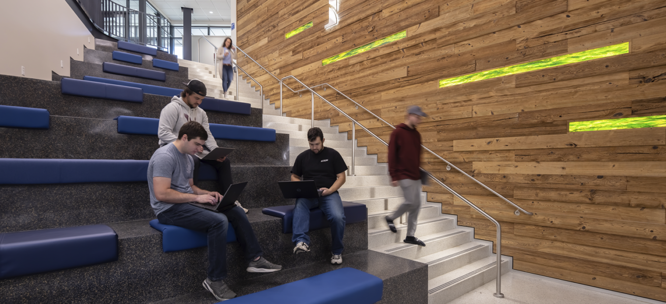 Students utilize the open seating in the Sesquicentennial Hall main staircase.