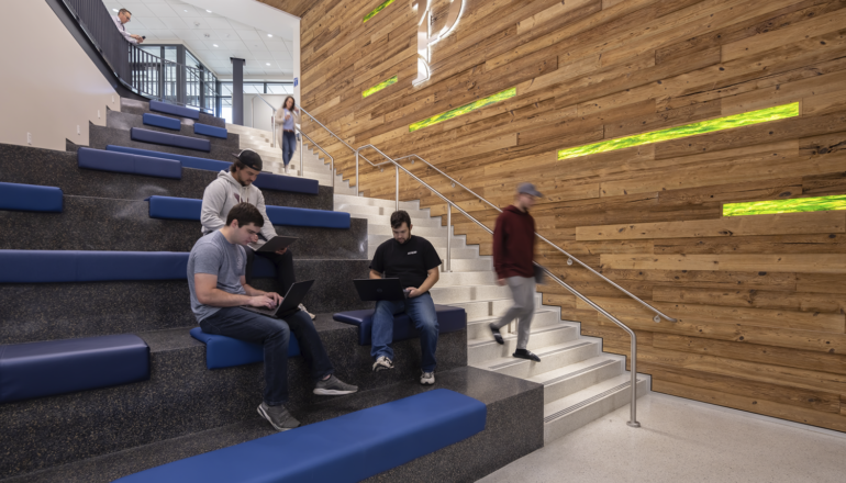 Students utilize the open seating in the Sesquicentennial Hall main staircase.