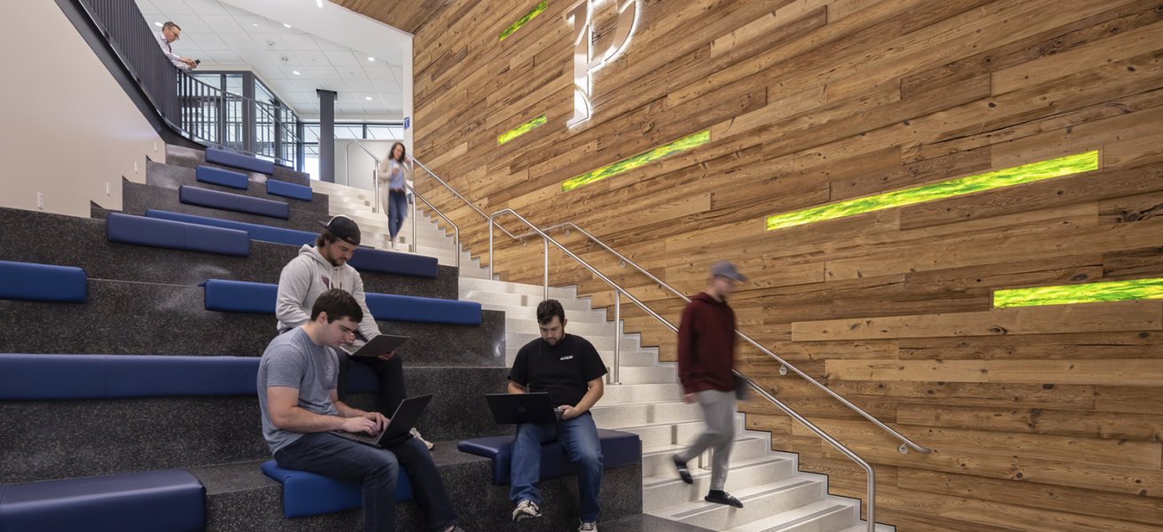 Students utilize the open seating in the Sesquicentennial Hall main staircase.