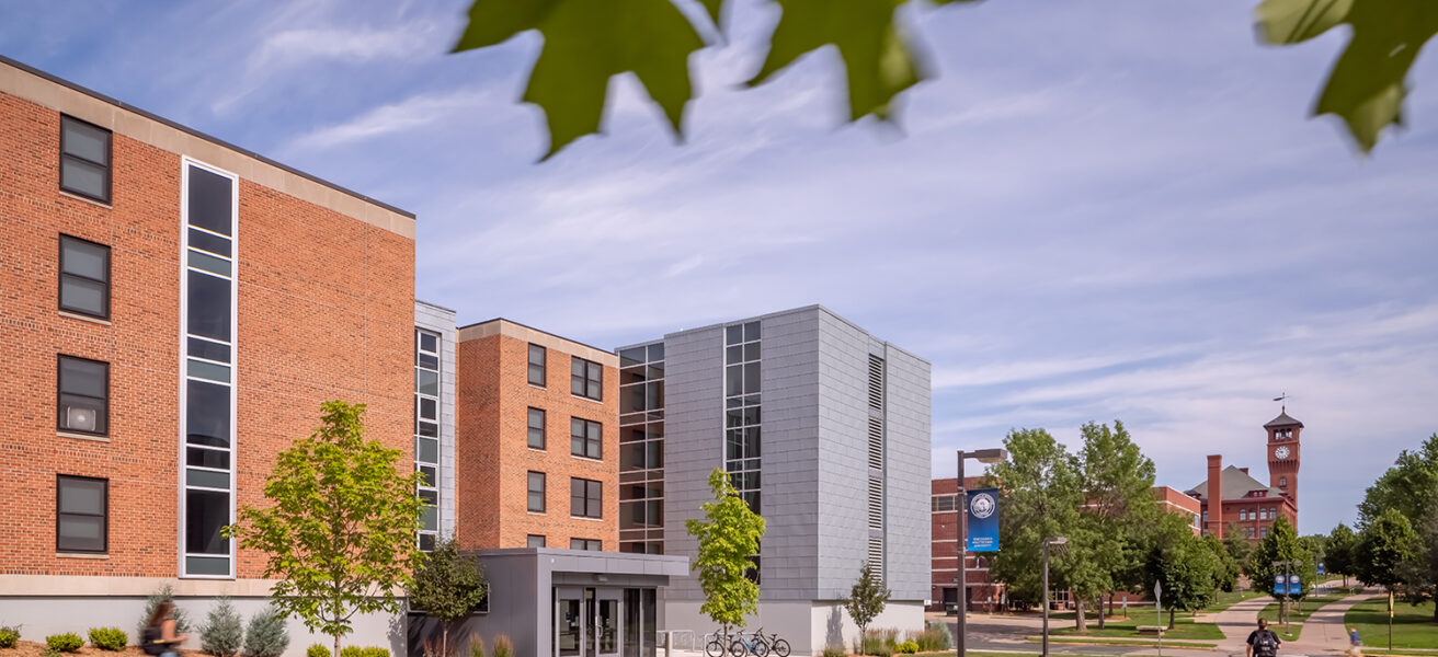 Exterior view of the North Residence Hall main entry looking toward the iconic campus clock tower