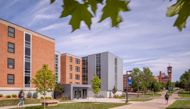 Exterior view of the North Residence Hall main entry looking toward the iconic campus clock tower