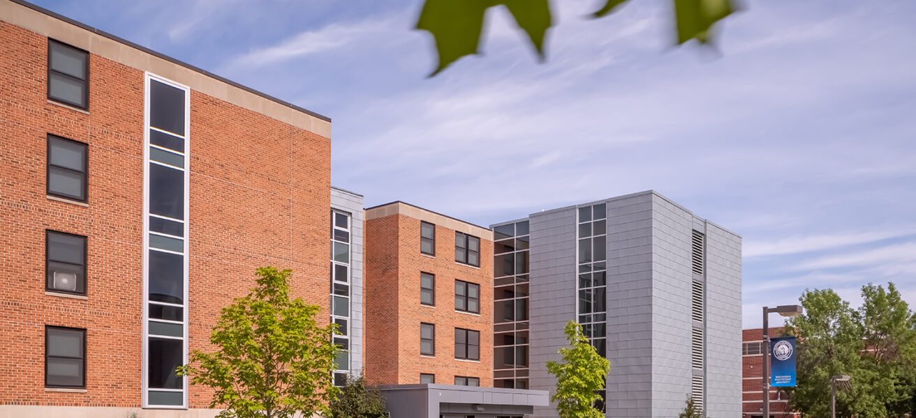 Exterior view of the North Residence Hall main entry looking toward the iconic campus clock tower