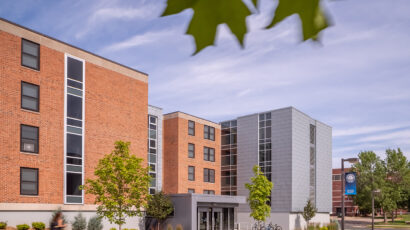 Exterior view of the North Residence Hall main entry looking toward the iconic campus clock tower