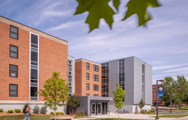 Exterior view of the North Residence Hall main entry looking toward the iconic campus clock tower