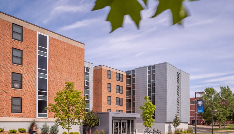 Exterior view of the North Residence Hall main entry looking toward the iconic campus clock tower
