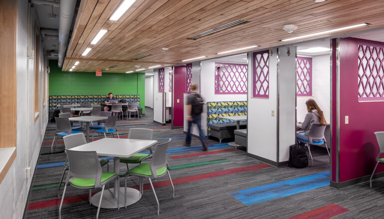 Students in one of the North Hall study lounges. Furniture, carpet, and paint all match the hall's living communities colors