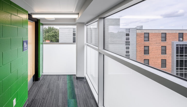 A green restroom entry matches the living community color in North Residence Hall