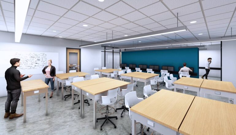 A senior design lab classroom with moveable furniture and a teal accent wall.
