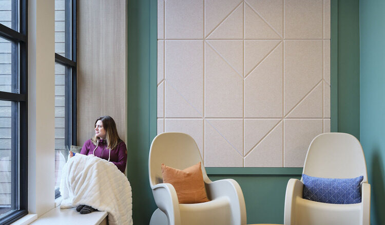 A person sits quietly in an alcove in the Maple Lane facility.