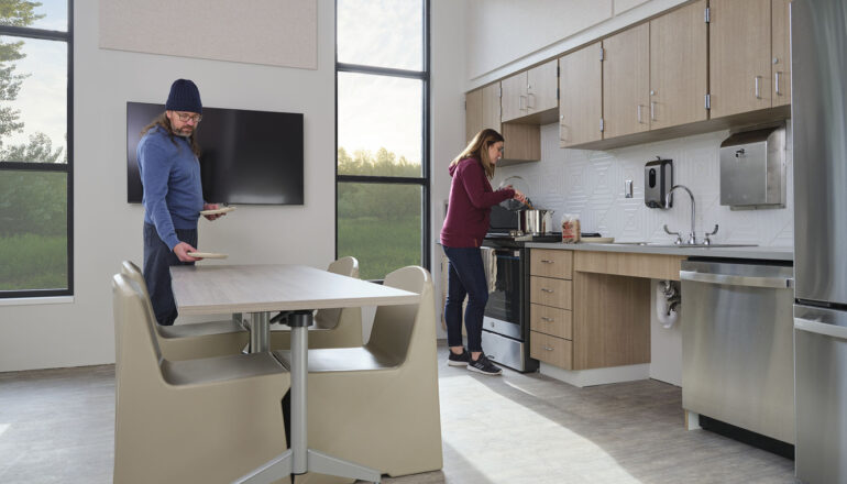 People use the kitchen and cafe space in the Maple Lane facility.