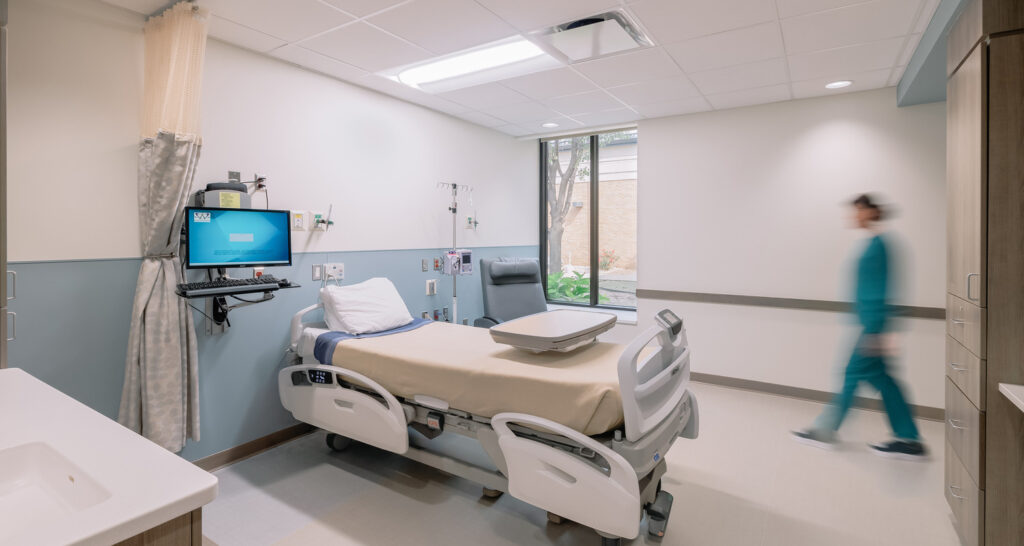 A nurse enters a patient room in the Antelope Memorial Hospital.