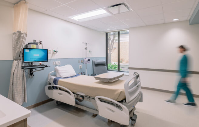 A nurse enters a patient room in the Antelope Memorial Hospital.